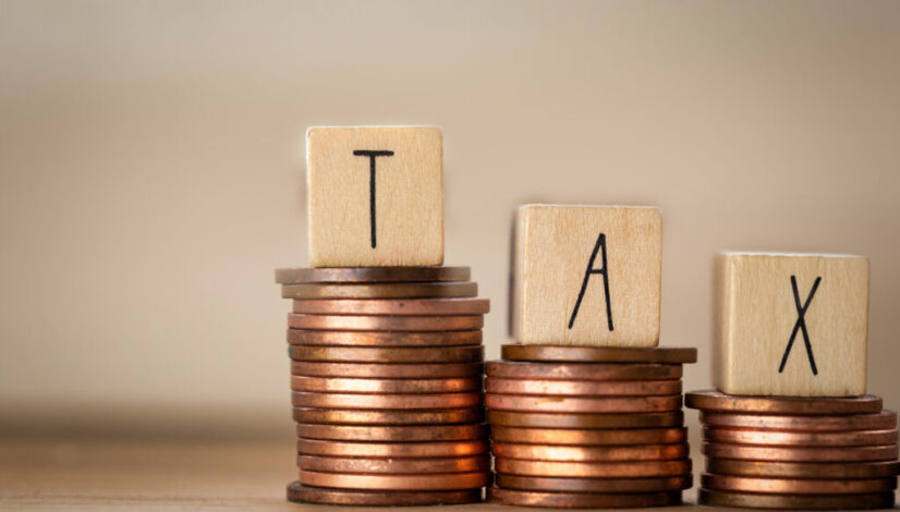 Wooden,Cubes,With,The,Word,Tax,On,Money,Climbing,Staits,